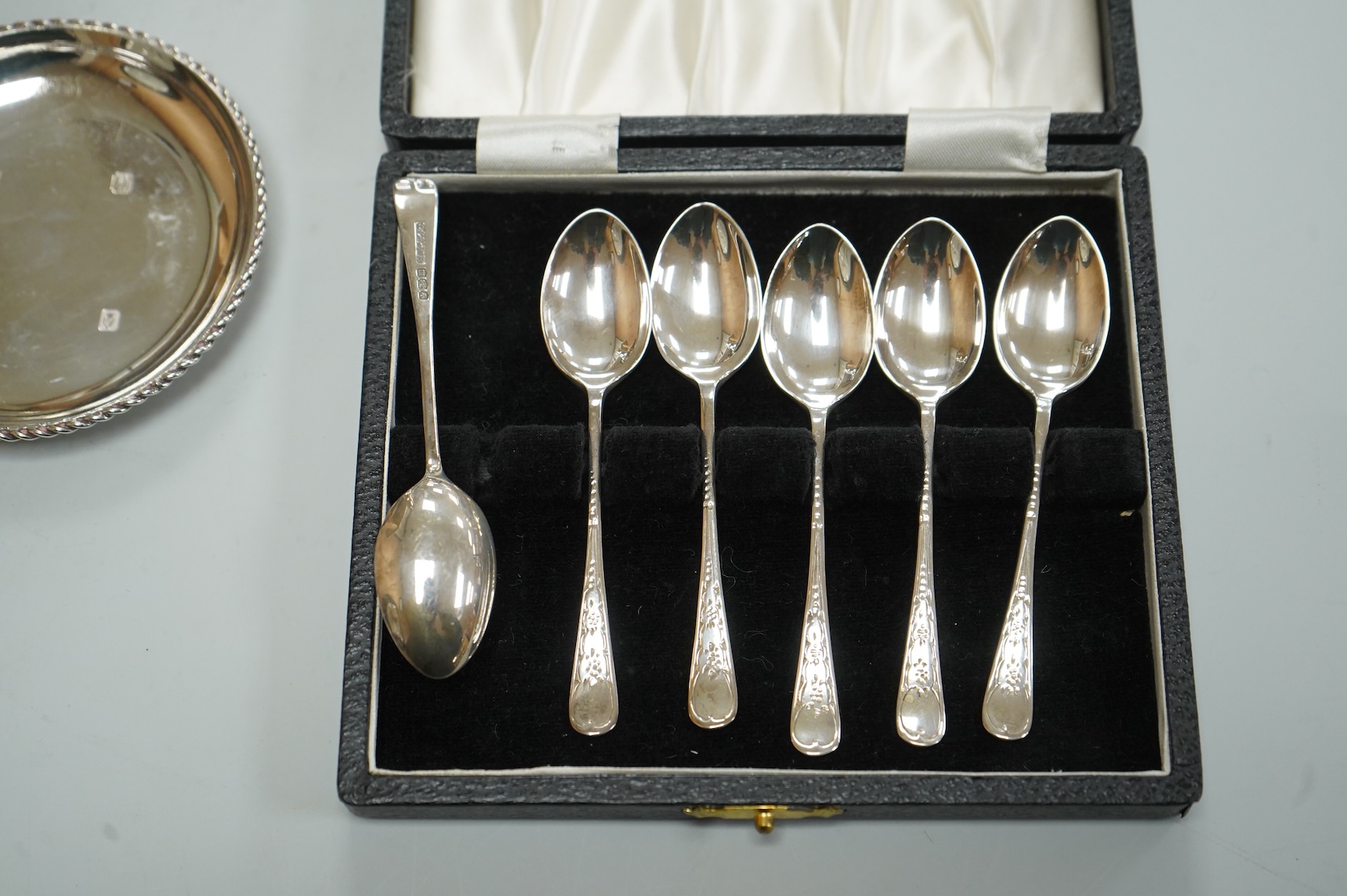 A George V silver sugar caster by Walker & Hall London 1932, 16cm, together with three silver nut dishes and a cased set of six silver coffee spoons.
